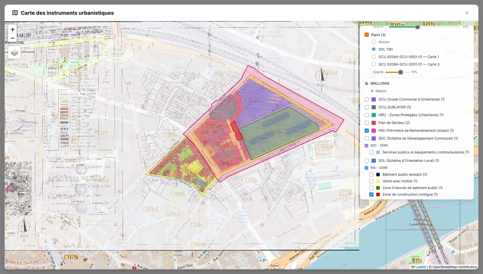 A single parcel viewed with a dozen overlapping regulatory layers — zoning plans, planning schemes, communal instruments — each colored differently on the map.